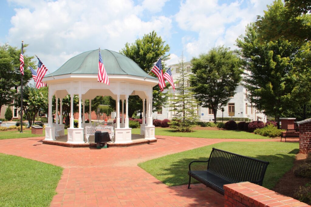The Cannon Park gazebo with American flags on the square in downtown Canton, GA